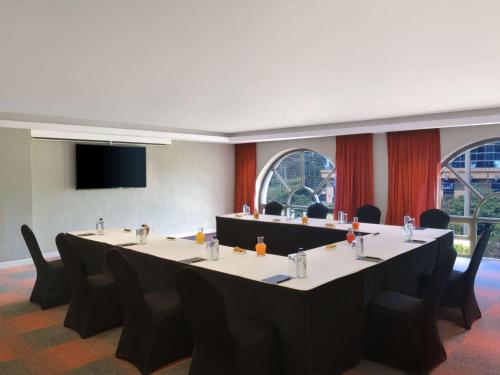 a meeting room with a long table and chairs at Pullman Nairobi Upper Hill in Nairobi
