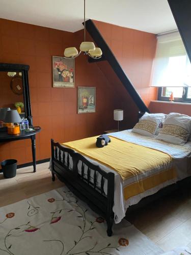 a bedroom with a large bed in a room at L’hirondelle du Faubourg in Saudemont