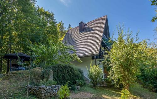a house with a tiled roof and a yard at 2 Bedroom Amazing Home In Mala Lesnica in Mala Lešnica