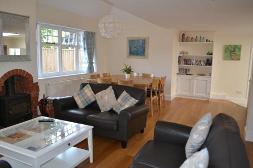 a living room with a couch and a table at Bentley Cottage in Brockenhurst