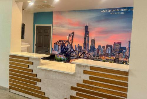 a wall with a mural of a city at La Quinta Inn & Suites by Wyndham South Holland in South Holland
