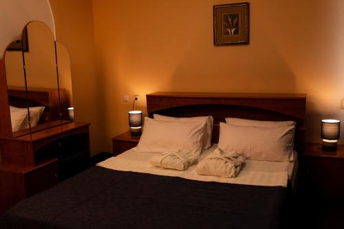 a bedroom with a bed with towels on it at Aktobe Hotel in Aktobe