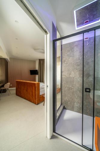 a room with a sliding glass door leading to a bedroom at Ypnos Rooms in Naples