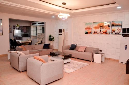 a living room with two couches and a table at Danag Apartments in Port Harcourt