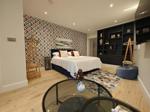 a bedroom with a bed and a glass table at Luxury 1-Bed Flat in Acton in London