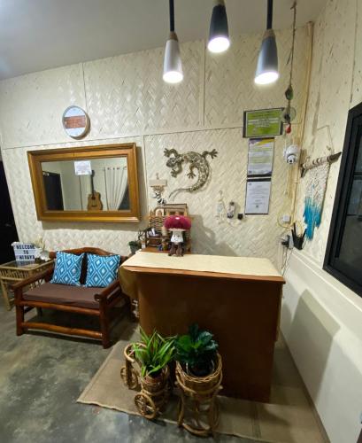 a bathroom with a tub and a mirror and a chair at Hiraya Homestay Coron in Coron
