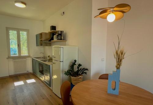 a dining room with a table and a refrigerator at HomeTerra in Brenzone sul Garda