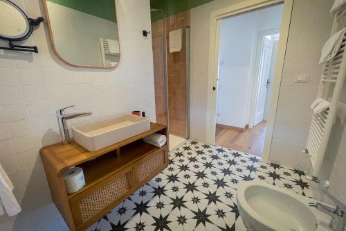 a bathroom with a sink and a toilet at HomeTerra in Brenzone sul Garda