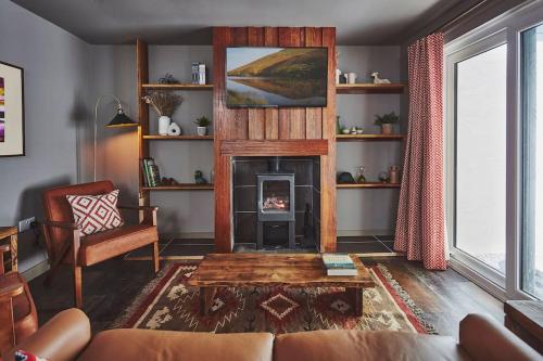 a living room with a fireplace and a couch at Craig Chat in Oban