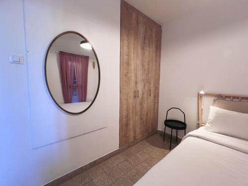 a bedroom with a mirror and a bed at הצימר של יהושע in Ein Gedi