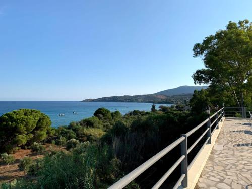 a boardwalk with a view of the water at De La Plage Hotel Koroni in Koroni