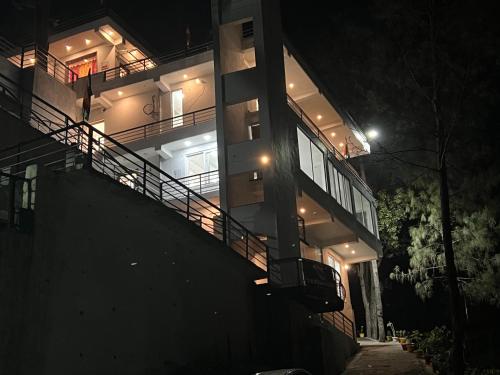 a building at night with its lights on at The Shalam Resort श्रीकृष्ण शरणं मम in Lansdowne