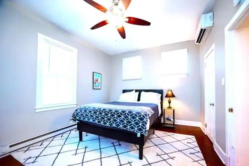 a bedroom with a bed and a ceiling fan at The Gilpin Getaway - 2BR - Free Coffee - apts in Wilmington