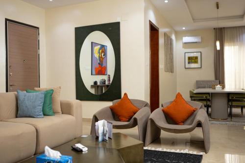 a living room with a couch and chairs and a table at Sunflower Residence, Ikoyi in Ikoyi