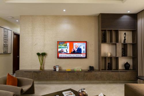 a living room with a tv on a wall at Sunflower Residence, Ikoyi in Ikoyi