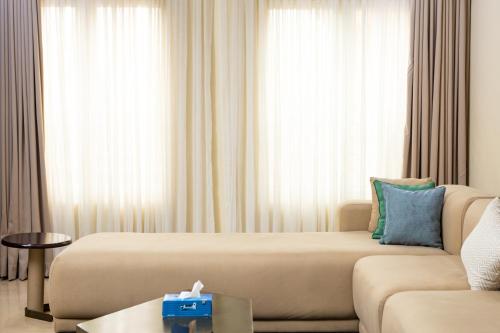 a hotel room with a bed and a couch at Sunflower Residence, Ikoyi in Ikoyi