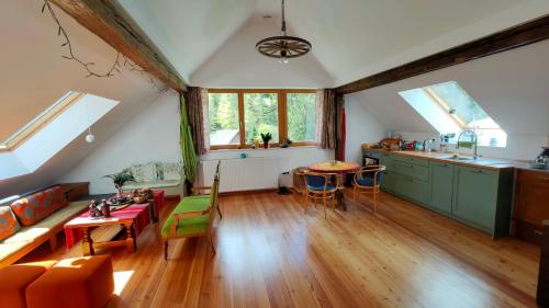 a kitchen and living room with a couch and a table at Pr Trnovc in Preddvor