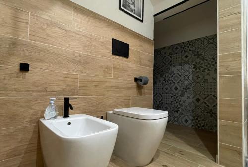 a bathroom with a white toilet and a sink at The downtown loft Carpi Centro in Carpi