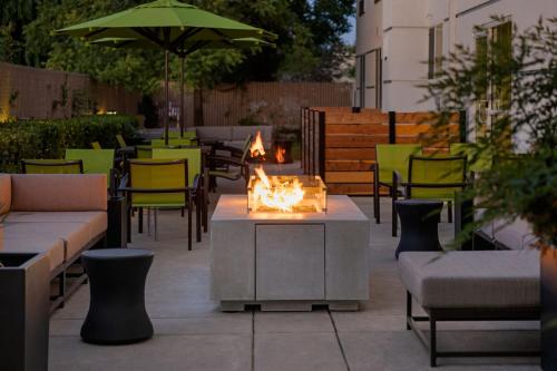 a fire pit on a patio with tables and chairs at SpringHill Suites by Marriott Turlock in Turlock