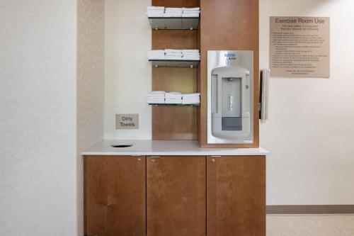 a bathroom with a towel dispenser on a wall at SpringHill Suites by Marriott Turlock in Turlock
