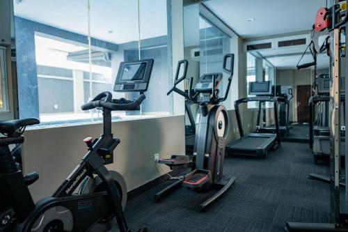 a gym with several cardio machines in a room at Sunflower Residence, Ikoyi in Ikoyi