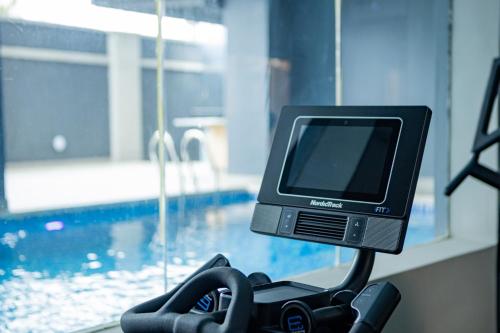a computer monitor sitting on a table next to a swimming pool at Sunflower Residence, Ikoyi in Ikoyi