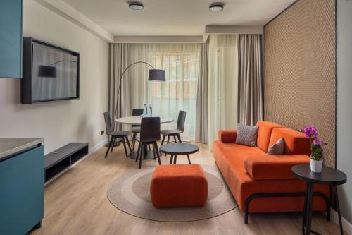a living room with a couch and a table at Escala Hotel & Suites in Budapest
