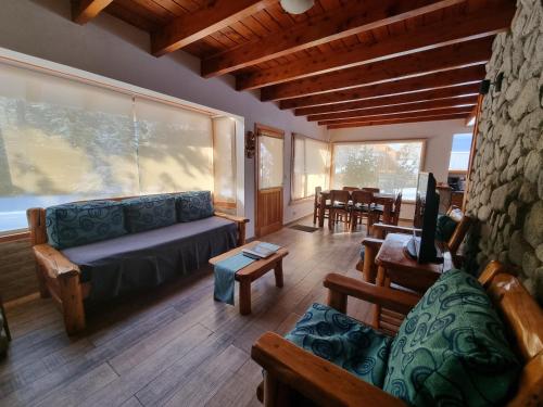 a living room with a couch and a table at Encanto del Rio in Villa La Angostura