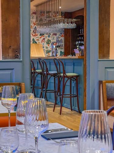 a table with wine glasses on it in a restaurant at The Great House Lavenham Hotel & Restaurant in Lavenham