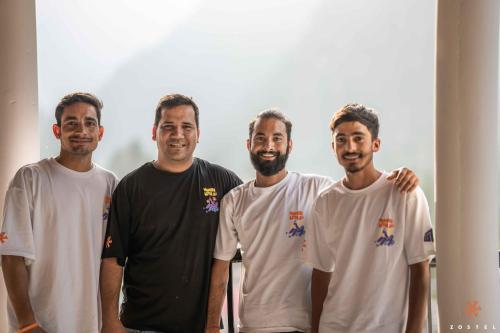 a group of four men posing for a picture at Zostel Pulga in Pulga
