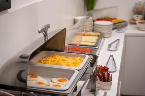 a kitchen with a buffet of food on a counter at Escala Hotel & Suites in Budapest