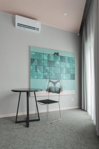 a table and a chair in a room at Resume apartments in Kaunas