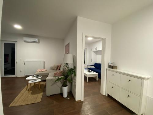 a living room with a couch and a table at LadyDi apartman in Banja Koviljača