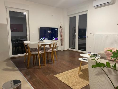 a living room with a dining room table and chairs at LadyDi apartman in Banja Koviljača