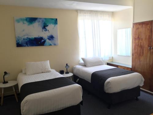Posteľ alebo postele v izbe v ubytovaní TRC Hotel