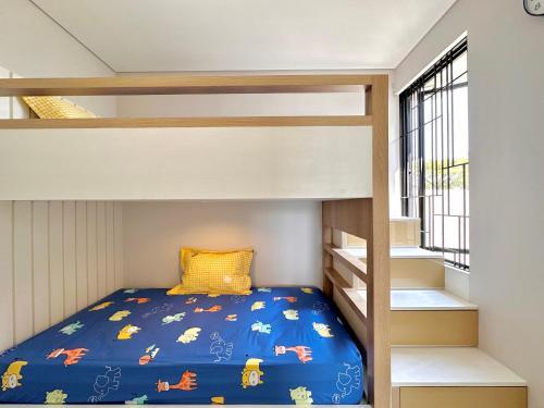 a bunk bed in a small room with a bunk bed in a house at Charming 4BR House in Northwest Park, West Surabaya by Le Ciel Hospitality in Surabaya