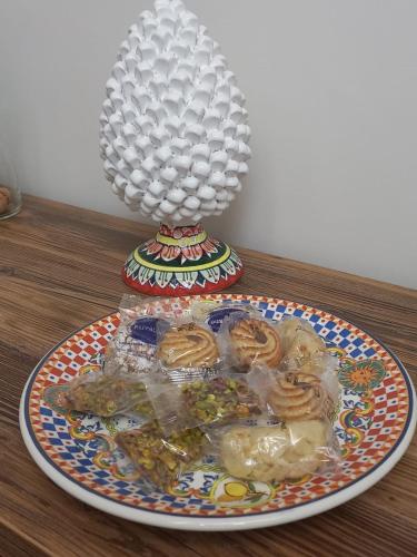a plate of food on a table with a lamp at Residenza del Massimo in Palermo