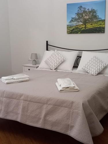 a bedroom with a bed with towels on it at Residenza del Massimo in Palermo