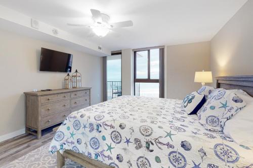a bedroom with a bed and a flat screen tv at Sea Colony - 606 Dover House Rd. in Bethany Beach
