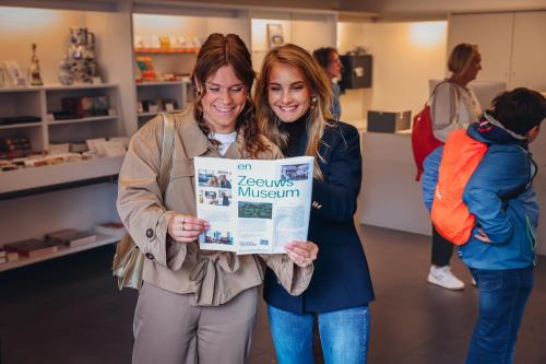 two women holding up a sign in a store at Van der Valk Hotel Middelburg in Middelburg