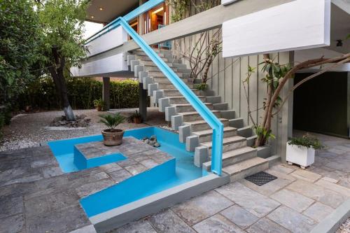 a set of stairs with blue risers in front of a house at Retro House in Rafina