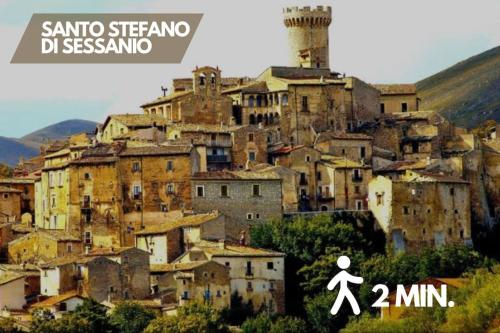 a person walking in front of a city at Cozy chalet "Da Silvio e Bruna" in Santo Stefano di Sessanio