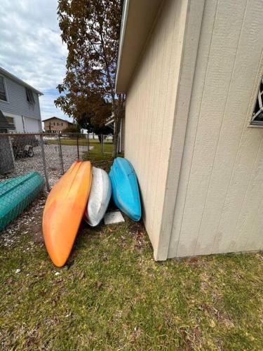 three kayaks are sitting next to a building at Cabin by the Sea - Waterfront Direct Gulf Access- Pontoon Boat Rental On Site or Bring Your Boat- Paddlecraft included in Hernando Beach
