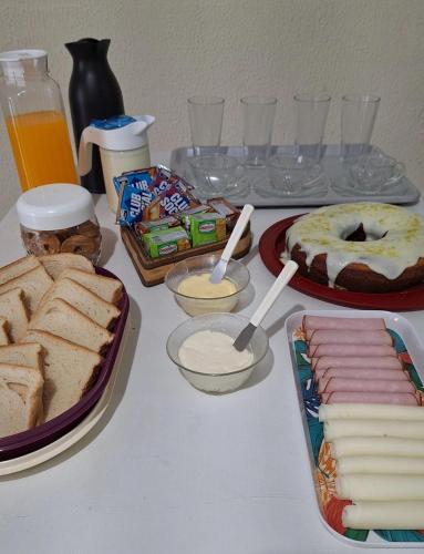 a table with bread and other food and drinks at Pousada Imperial in Itaboraí
