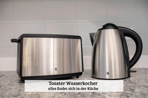 a black and silver toaster on a kitchen counter at LenHaus Sundern - Ferienhaus mit Kamin & Garten in Sundern