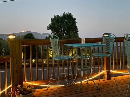 a table and chairs on a deck with lights at Skyline Village Inn in Spruce Pine