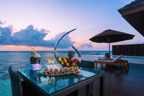 a tray of food on a table on the beach at Lily Beach Resort and Spa - All Inclusive in Dhangethi