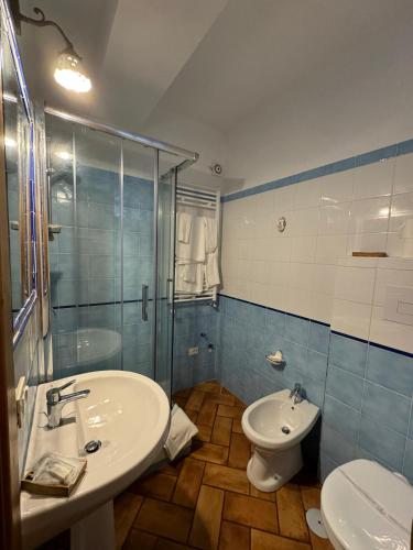 a bathroom with a sink and a toilet and a shower at B&B Antico Casale in Fuscaldo