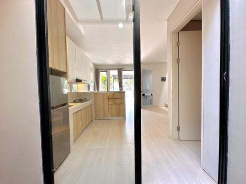 a kitchen with a glass door leading to a dining room at Charming 4BR House in Northwest Park, West Surabaya by Le Ciel Hospitality in Surabaya