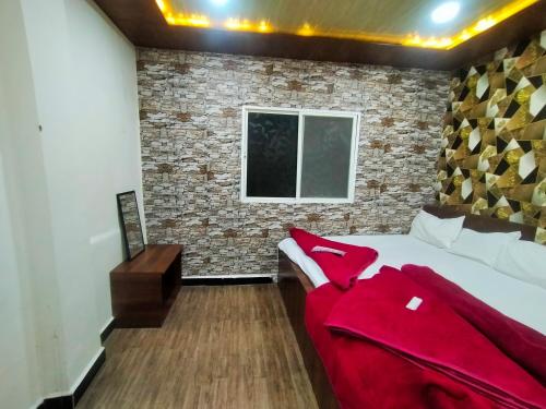 a bedroom with a bed and a brick wall at junagadh places in Ujjain